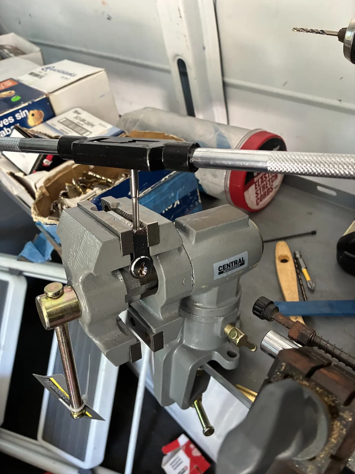 Locksmith key preparation tools secured at a workbench
